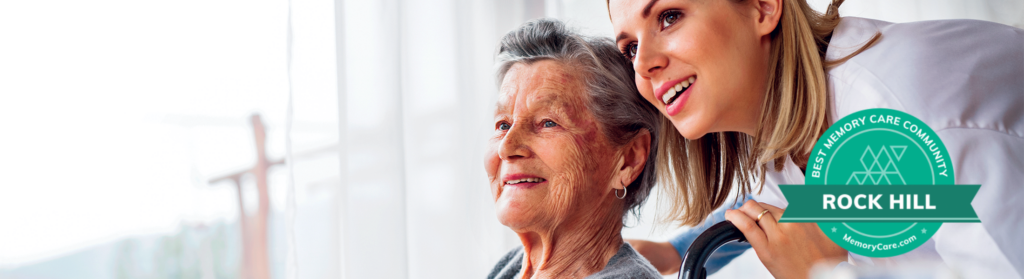 Two women smiling, with best memory care community badge