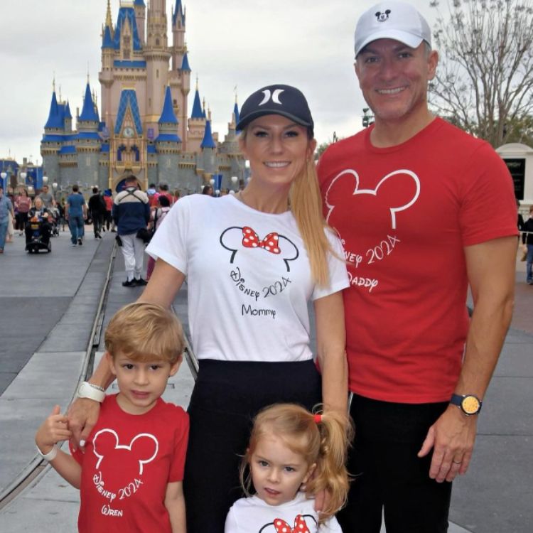 Sevy Petras with her family at Disney in front of the Disney castle.