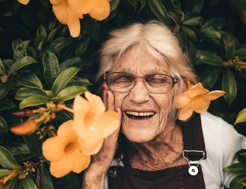 Senior woman smiling with flowers